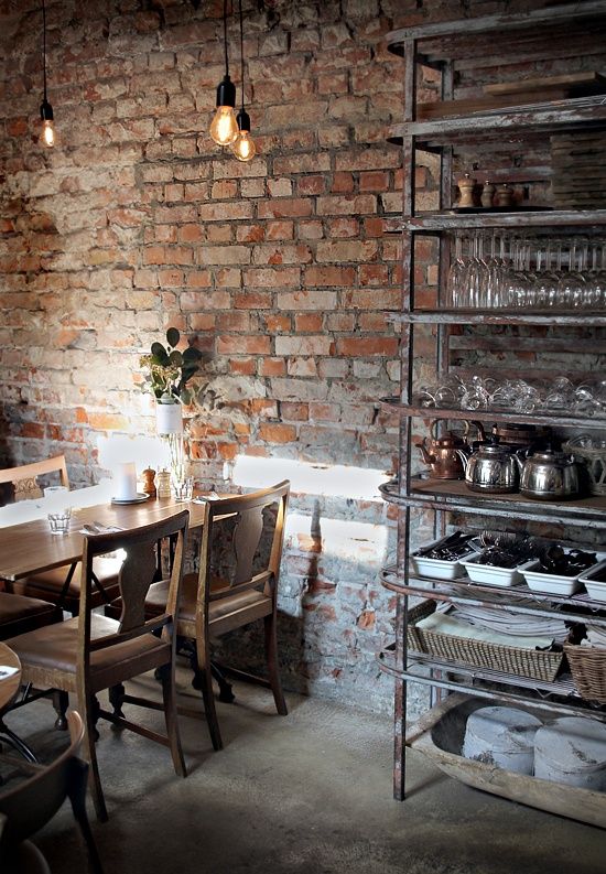 Brick-wall-wooden-table-and-chairs-and-metal-shelf-industrial-interior-design
